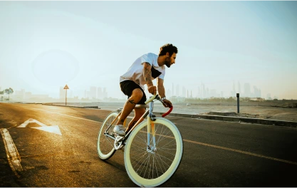 A cyclist riding their bike at sunset